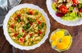 Instant noodles in white bowl on wooden table background and vegetables salad Royalty Free Stock Photo