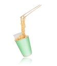 Instant noodles on wooden chopstick from a cardboard cup on a white background Royalty Free Stock Photo