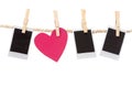 Instant photographs and heart shape hanging on a Royalty Free Stock Photo