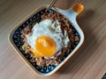 instantly fried noddle with a fried egg with wooden background