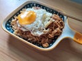 instantly fried noddle with a fried egg with wooden background