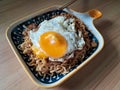 instantly fried noddle with a fried egg with wooden background Royalty Free Stock Photo