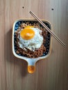 instantly fried noddle with a fried egg with wooden background