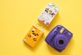 Fujifilm instax mini camera and gudetama and Winnie the Pooh instant film on yellow background