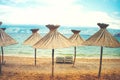 Instragram retro effect on photo, beach umbrellas with straws Royalty Free Stock Photo