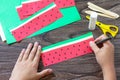 Instruction step 4. Paper Fan watermelon and origami paper ice cream on a wooden table. Childrens art project, handmade, crafts