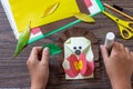 Instruction step 10. Postcard hedgehog with an apple on a wooden table. Handmade. Project of children`s creativity, handicrafts, Royalty Free Stock Photo