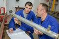 Instructor and apprentice looking at pipe Royalty Free Stock Photo
