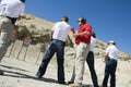 Instructor Assisting People Aiming Guns At Firing Range