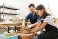 Instructor Assisting Student In Making Pottery Royalty Free Stock Photo