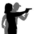 Instructor assisting woman aiming hand gun at firing range Royalty Free Stock Photo