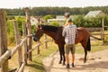 Instructor and child on a brown horse