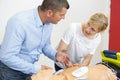 Instructor demonstrating cpr chest compression on dummy Royalty Free Stock Photo