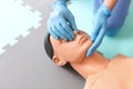 Instructor demonstrating CPR on mannequin at first aid training course Royalty Free Stock Photo