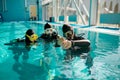 Instructor and divers in aqualungs, dive lesson Royalty Free Stock Photo