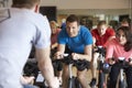 Instructor in foreground with spinning class at a gym Royalty Free Stock Photo