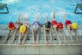 Instructor and group of children doing exercises near a swimming pool Royalty Free Stock Photo