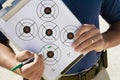 Instructor Holding Clipboard With Target Diagram