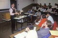 An instructor lecturing business management class