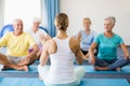 Instructor performing yoga with seniors Royalty Free Stock Photo