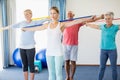 Instructor and seniors exercising with stretching bands