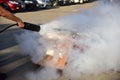 Instructor showing how to use a fire extinguisher on a training Royalty Free Stock Photo