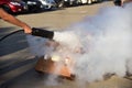 Instructor showing how to use a fire extinguisher on a training Royalty Free Stock Photo