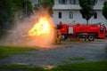 Instructor showing how to use a fire extinguisher on a training Royalty Free Stock Photo