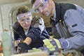 Instructor showing trainee carpentry work