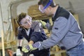 Instructor showing trainee carpentry work