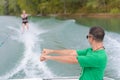 Instructor showing woman position for water skiing