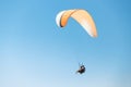 Tandem flying in the air on a large paraglider. Blue sky in the background. Active lifestyle and
