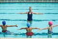 Instructor teaching students in swimming pool Royalty Free Stock Photo