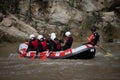 Instructor and team practicing rafting down the river as a seasonal adventure