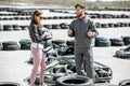 Instructor with woman on the track with go-karts Royalty Free Stock Photo