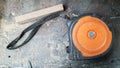 Instrument measuring tape under a layer of dust on a table in a workshop