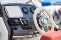 Instrument panel and steering wheel of a motor boat cockpit yacht control bridge. Royalty Free Stock Photo