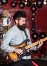 Instrumentalist concept. Musician with beard play electric guitar