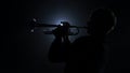 Instrumentalist plays on a trumpet classical melody. Studio in smoke