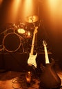 Instruments, guitar and drums for band at stage for concert and performance of music with talent. Electric, equipment Royalty Free Stock Photo