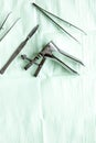 Instruments of gynecologist on green background top view mock up