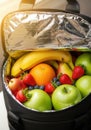 Insulated lunch bag filled with fresh fruit assortment Royalty Free Stock Photo