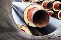 Insulated pipe. Large metal pipes with a plastic sheath at a construction site. Modern pipeline for supplying hot water and Royalty Free Stock Photo