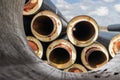 Insulated pipe. Large metal pipes with a plastic sheath at a construction site. Modern pipeline for supplying hot water and Royalty Free Stock Photo