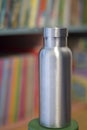 Insulated Stainless Bottle with colorful bookshelf background Royalty Free Stock Photo
