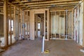 Insulating the wall with mineral fiberglass wool between the beams framing it in order to provide it with thermal and