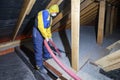 Insulation of the attic with cellulose insulation. Spraying from a hose Royalty Free Stock Photo