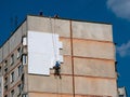 Insulation and Energy Saving Technology Concept. Worker Making Building with heat insulated facade Royalty Free Stock Photo