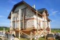 Insulation of the house with facade bricks, construction of a new house and scaffolding near the walls Royalty Free Stock Photo