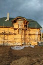 Insulation of the house with facade bricks, construction of a new house and scaffolding near the walls Royalty Free Stock Photo